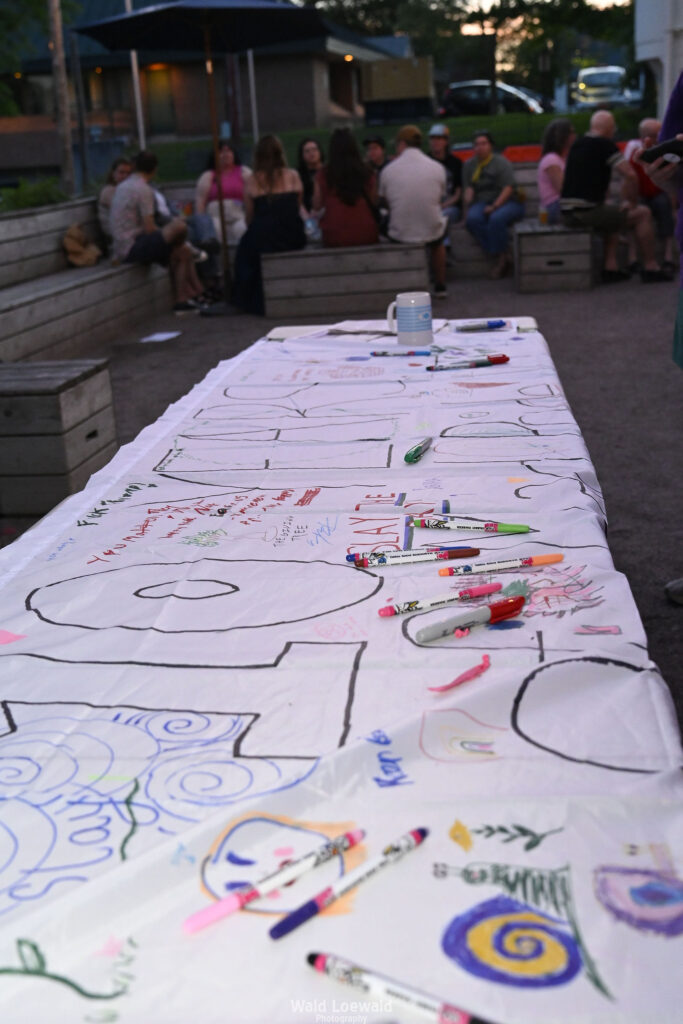 White banner with colored markers