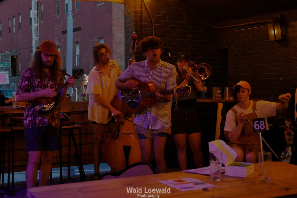 Marxist Jargin holding string and brass instruments performing