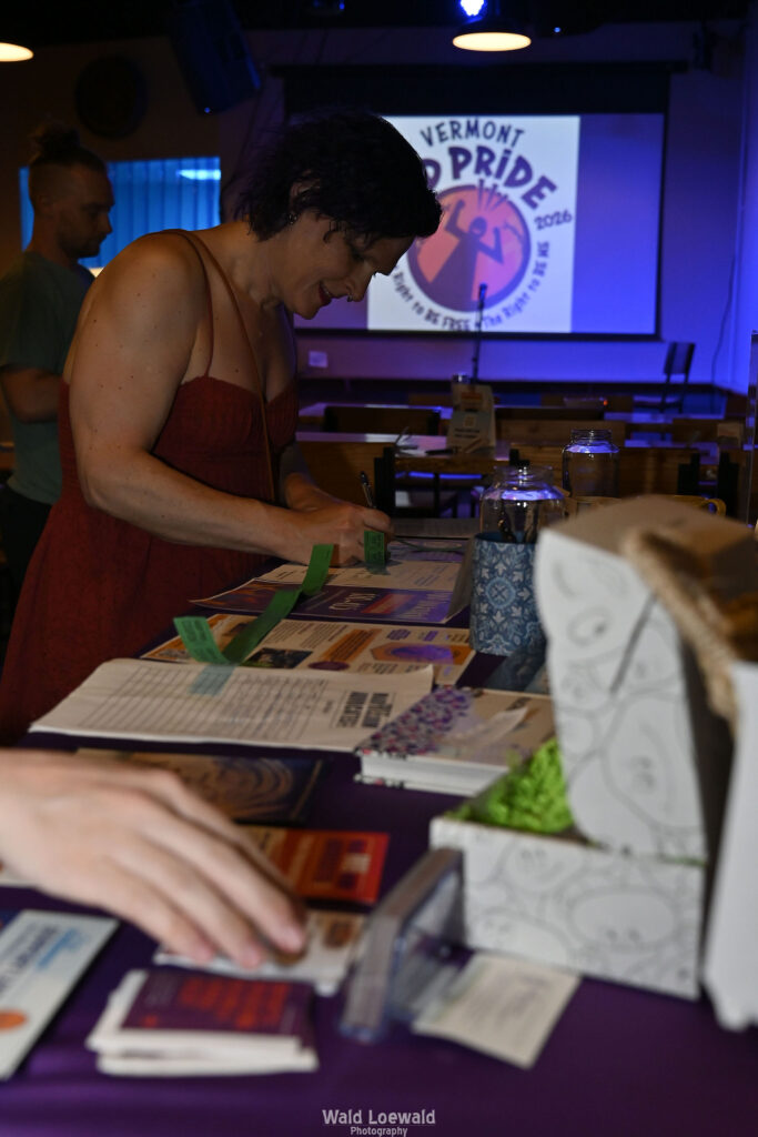 People surrounding MadFreedom Advocates table looking at materials